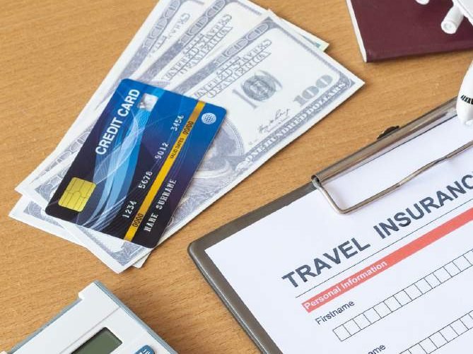 Travel insurance form with passport, cards and currency