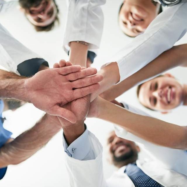 Team joining hands in a circle